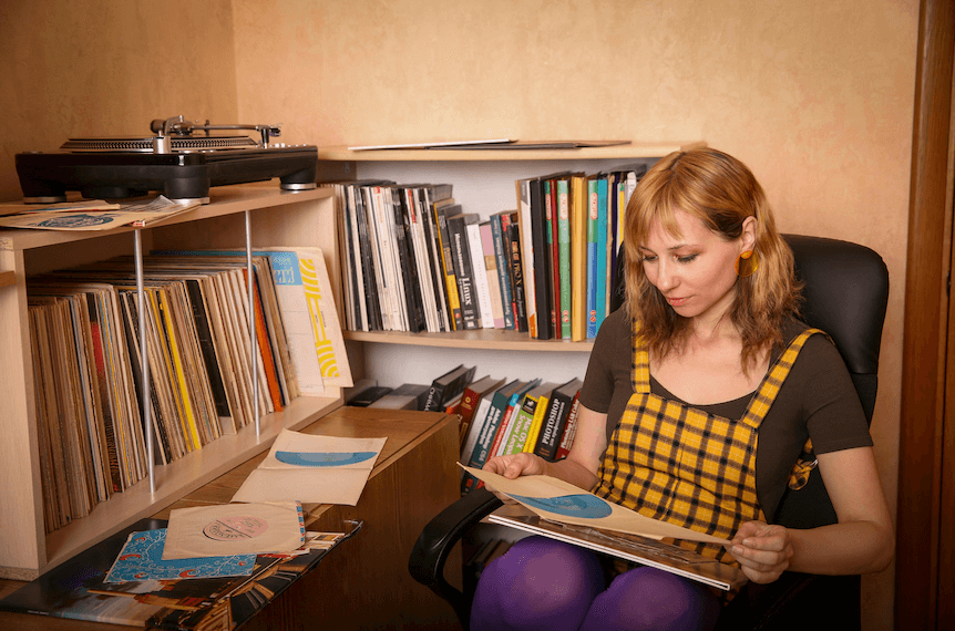 A girl studying one of the custom records in her collection